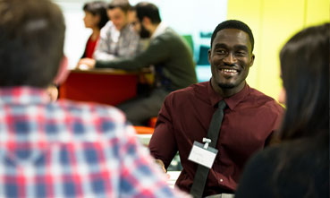 Male student in a group at The University of Manchester