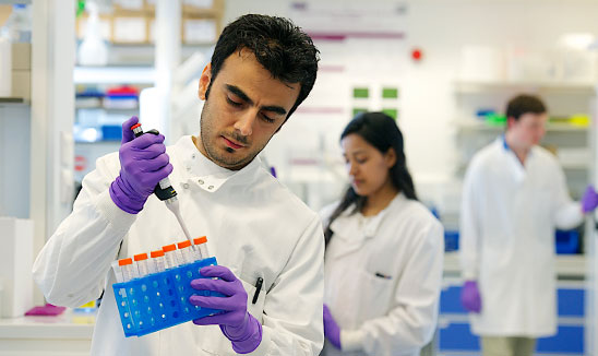 Research student in a lab at The University of Manchester's Faculty of Biology, Medicine and Health